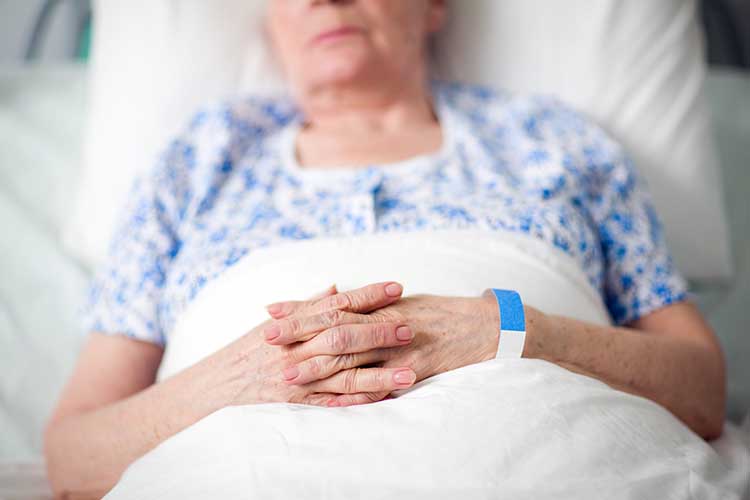 An elderly woman in bed