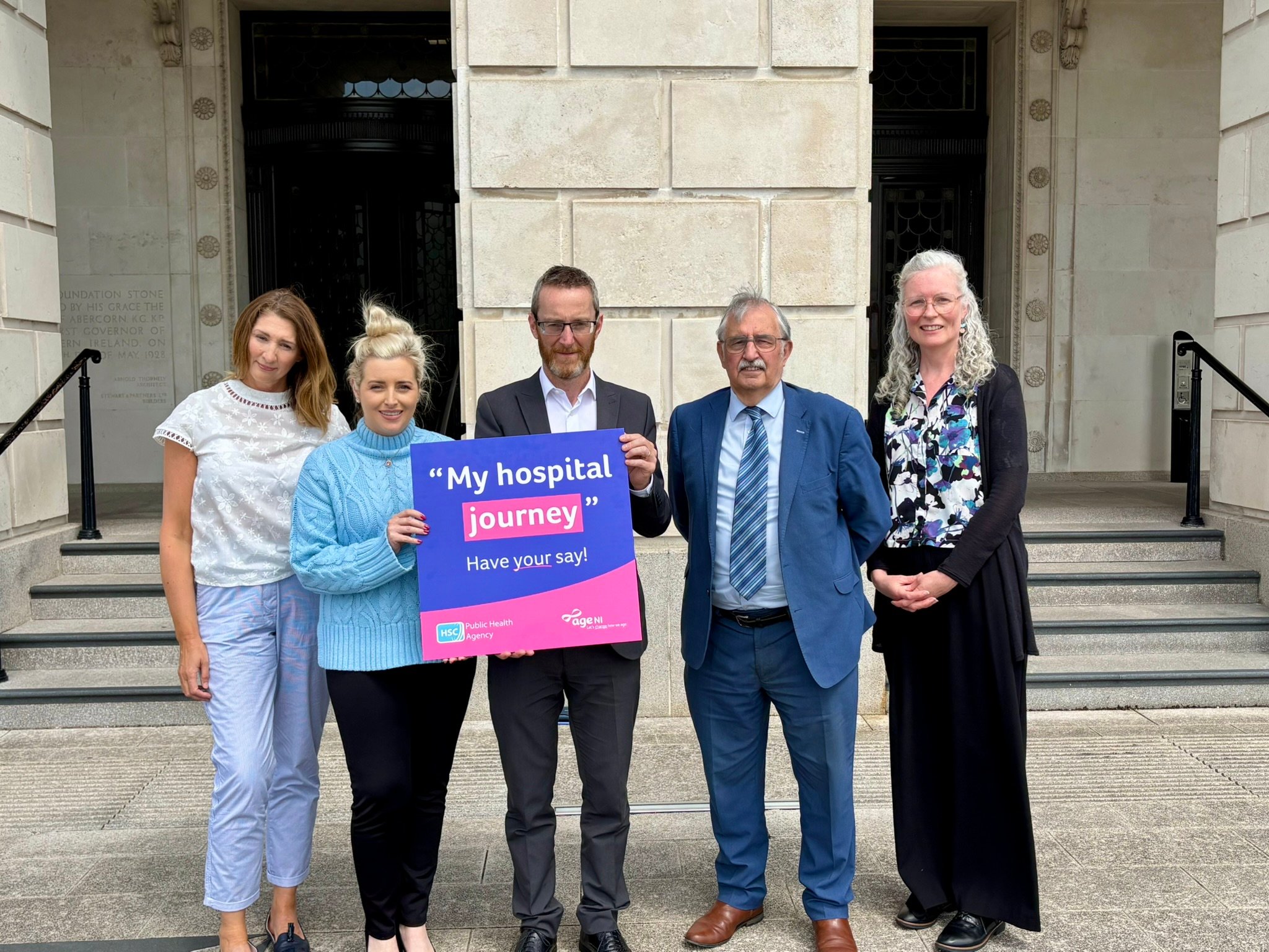 group standing outside Stormont Parliament Buildings holding a sign that reads "My hospital journey"