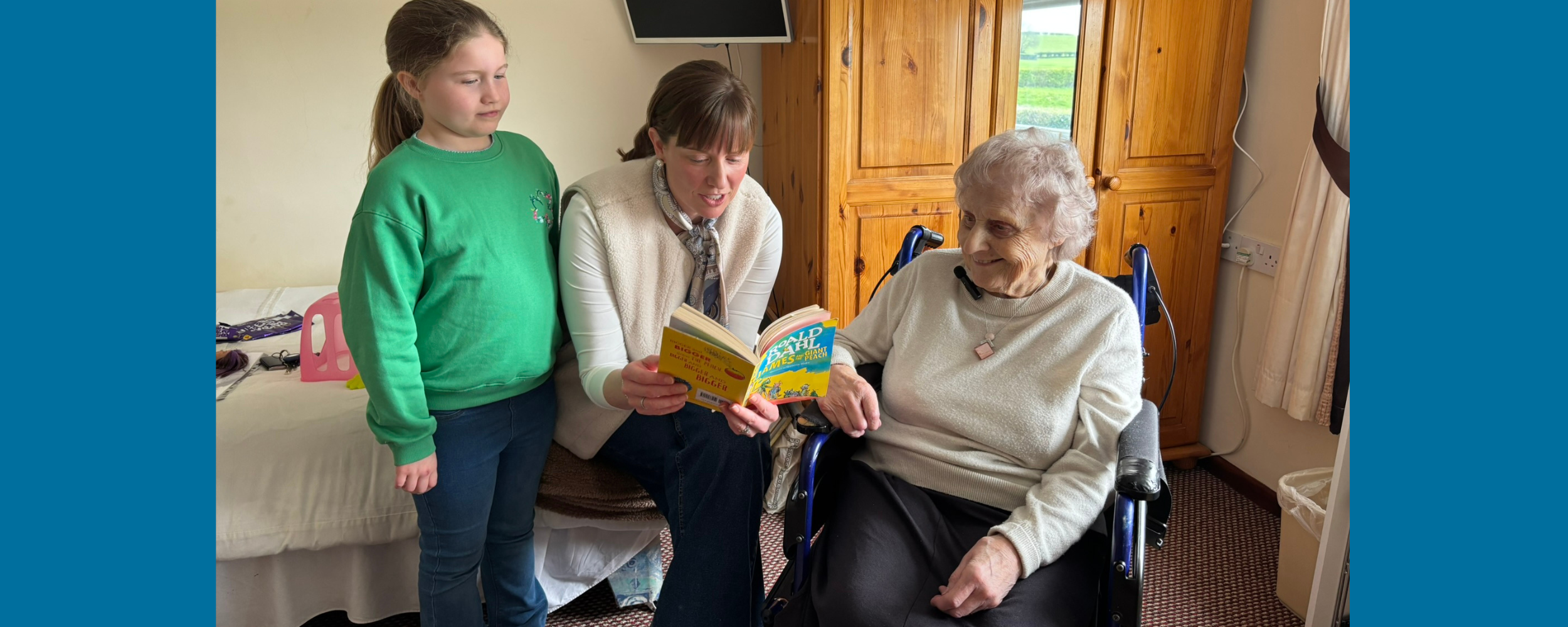 blue background with photo of a young girl, a woman, and an older woman reading a book and laughing