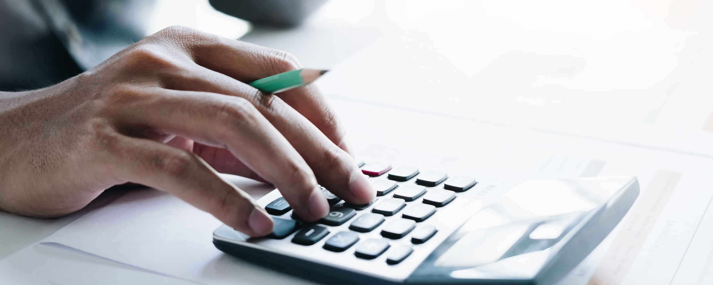 hand typing on a calculator