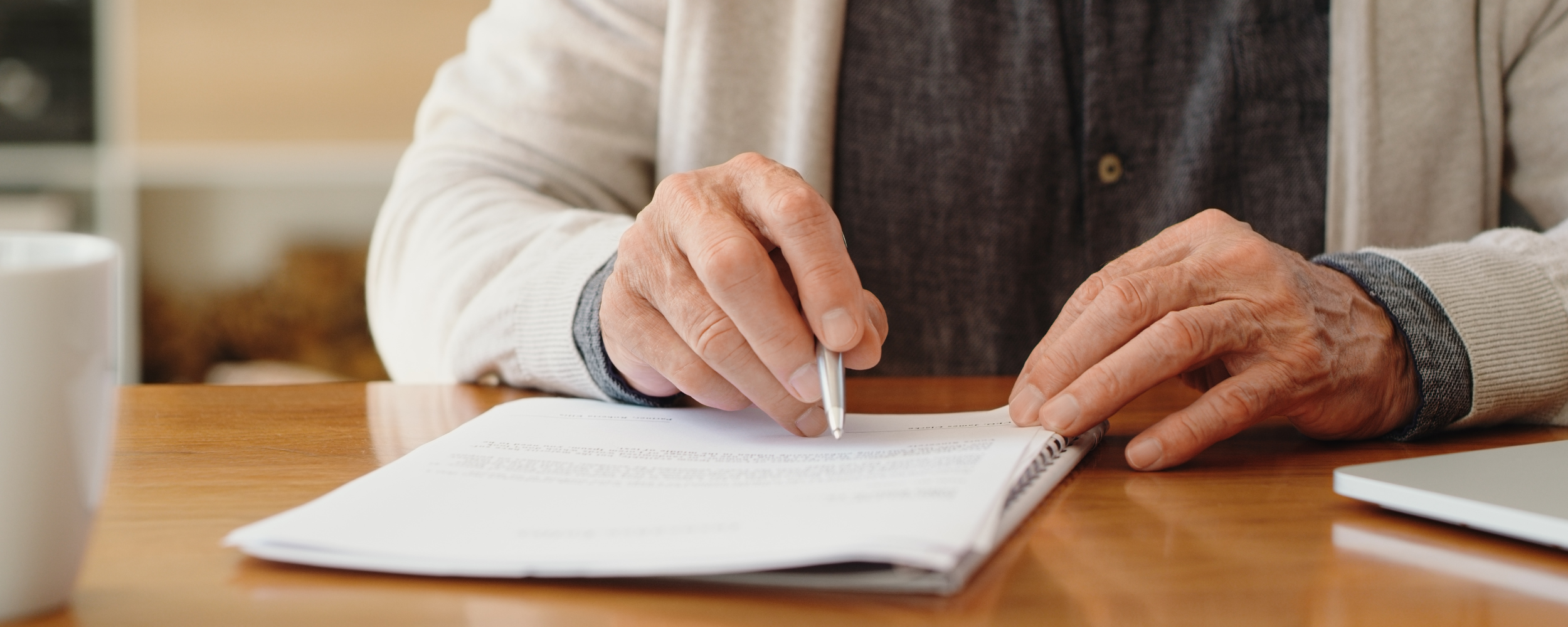 closeup on an older person filling out a form