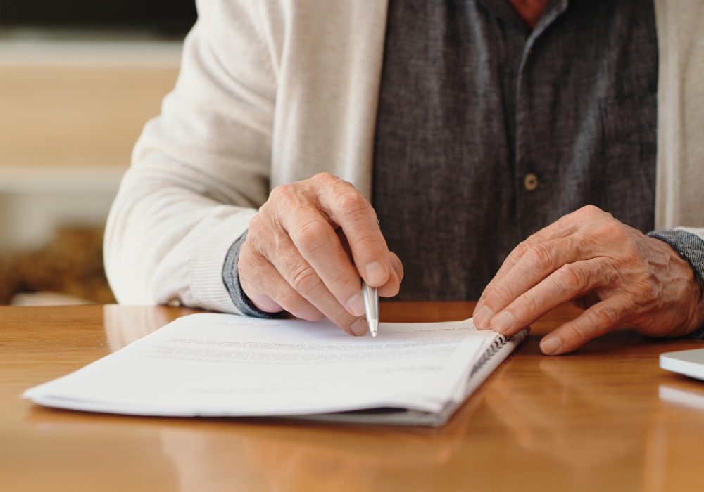 closeup of an older person filling out a form