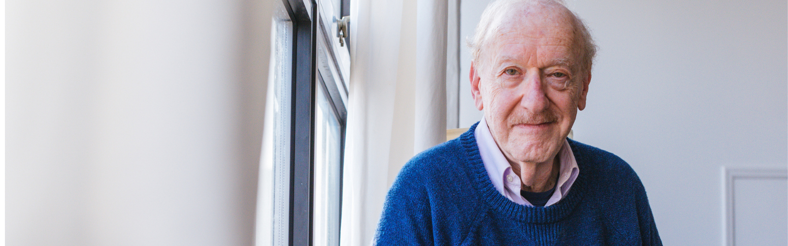 Older man wearing a blue jumper