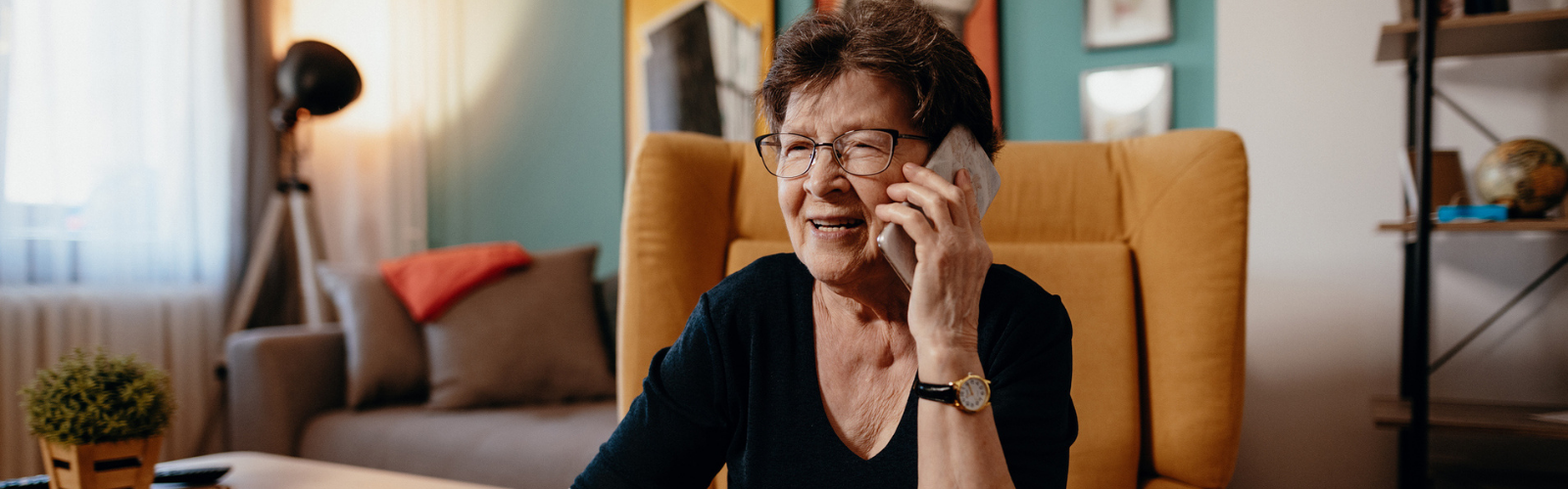 Older woman on the phone looking at a bill